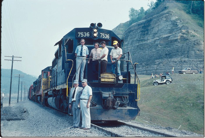 On the ground are Pike Co. judge executive Wayne Rutherford and Pikeville Mayor William Hambley (deceased). In the blue shirt with tie is C&O road foreman of engines Paul Kelly (deceased). The other three are the train crew. 07-07-1978. C&O in Pikeville KY.