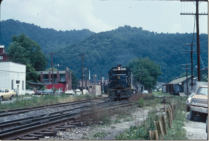 The railroad would be moved out of town in a few years. Here an eastbound C&O empty coal train passes the old freight depot on the right. That’s Hellier St. on the left. 06-26-1973. Pikeville KY.