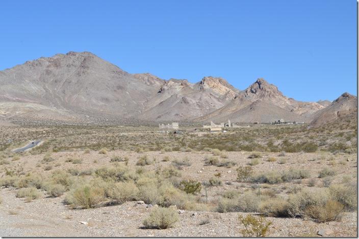 The abandoned school, Cook Bank, Overbury Bldg., and LV&T depot. Rhyolite NV in the distance.