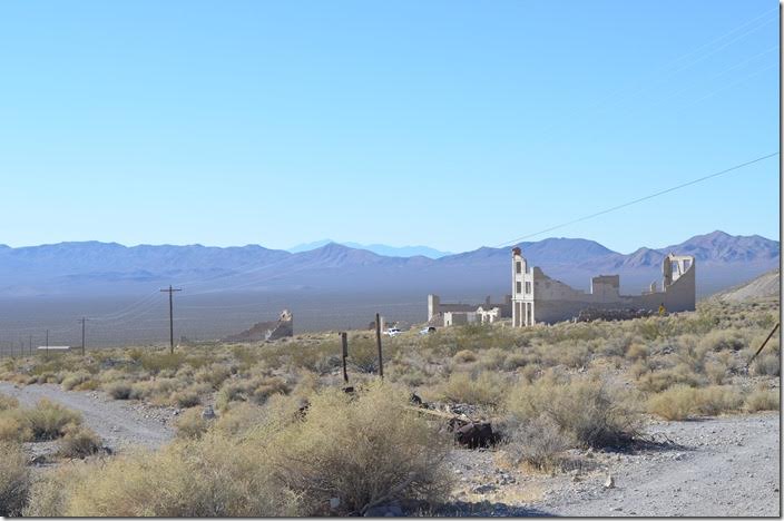 View from the LV&T depot looking down the hill at the ruins of the buildings. Death Valley would be across the Funeral Mountains in the distance. Abandoned buildings. Rhyolite NV.