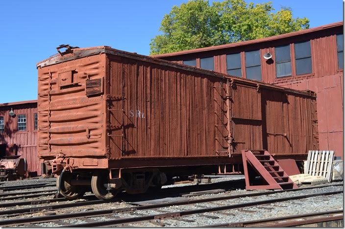 From the evidence I saw, this SRy boxcar is former Western Pacific. To the right of the steps is the supply of refractory brick for a locomotive fire box.