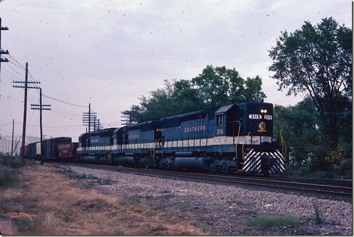 Southern 3119-3131-3155 (all SD45s) head onto their own track with e/b freight 111. 09-25-1981.
