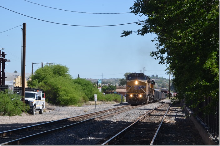 I talked with one of the numerous border patrol officers, and he revealed that a southbound freight would be arriving within the hour. The area to the left of the train was once the SP yard and roundhouse. At 9:55 AM a headlight appeared. UP 5828-6396. Nogales AZ.