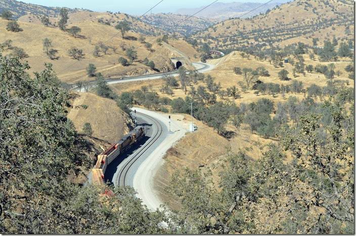We head back over the hill and down Tehachapi-Woodford Road. An eastbound UP freight was slowly moving upgrade with distributed power units 6678-7817 pushing. Tunnel 10.