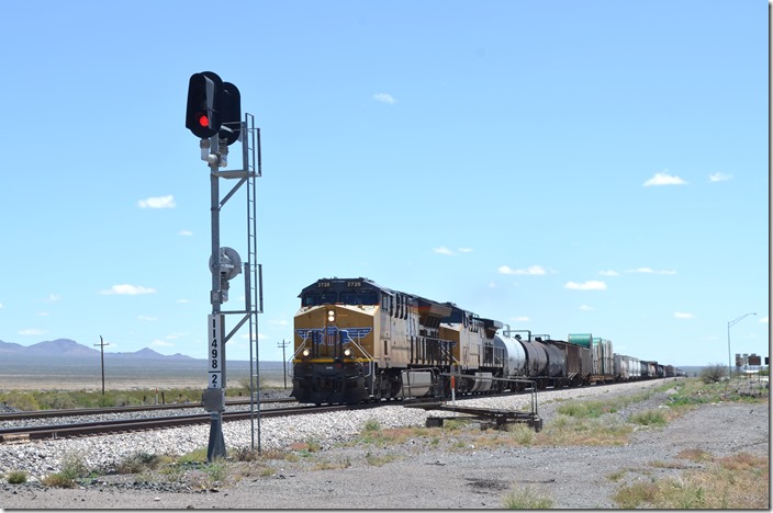 UP 2728-7254 sail through town with a w/b freight and intermodal. Lordsburg NM.