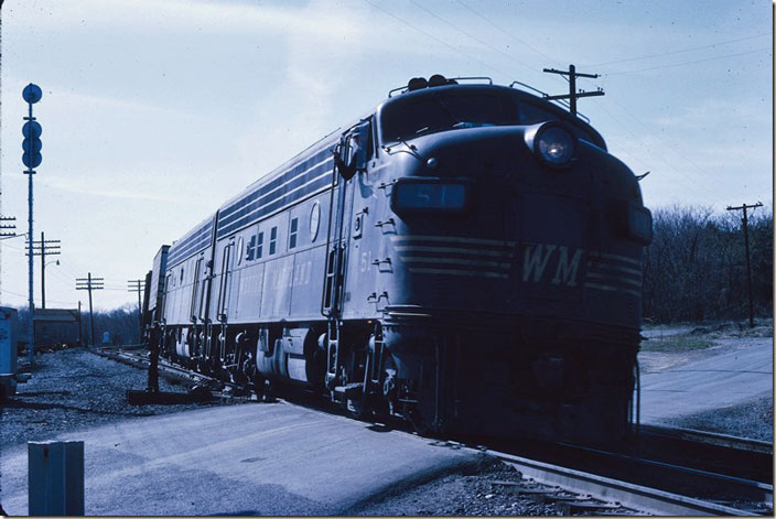 The engineer on F7a 51 and F9b 413 gives a wave and will grab a train order or message off the stand. This freight could have been an AJ-2 (Alpha Jet) which ran from Bellevue OH to Rutherford PA using the N&W (P&WV route), WM and Reading. The other eastbound freight – WM-6 – would have been at night. WM Williamsport MD.